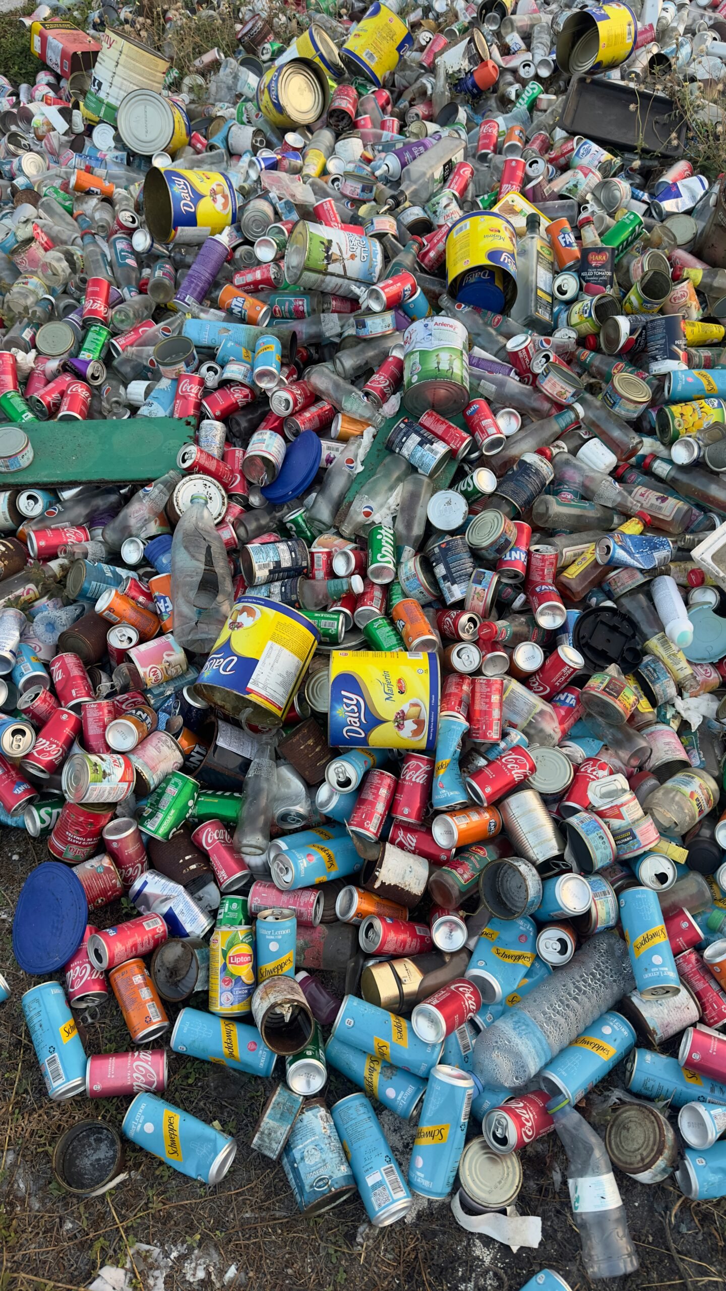 a pile of cans and cans of various sizes and colors